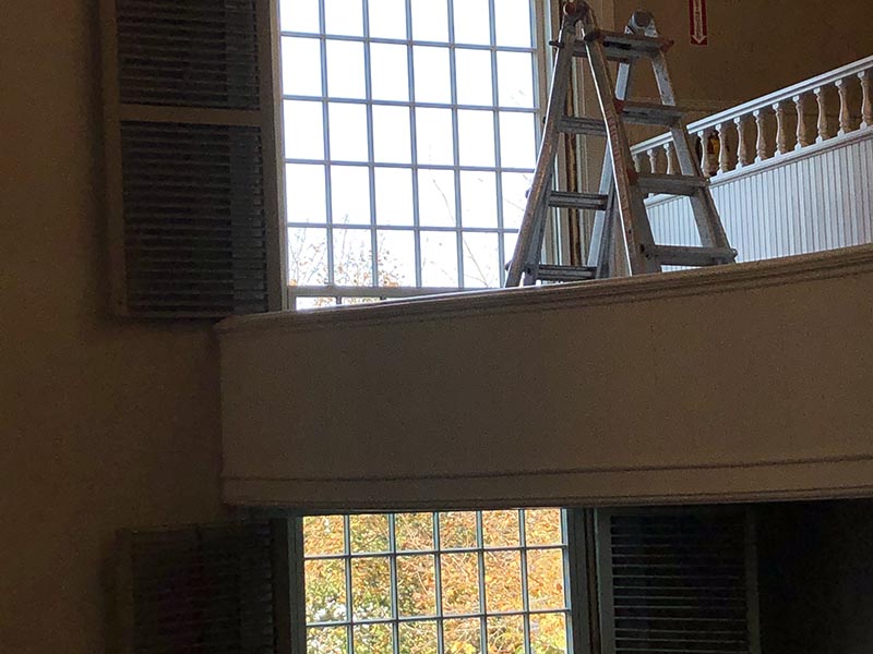 Window behind the second floor balcony 