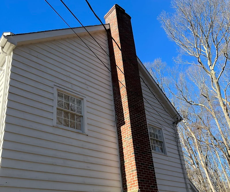 Wood single pane double hungs windows on the side of a fireplace in WIlton, CT