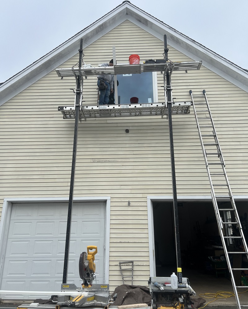 Installing PVC rot free trim around this picture window in Redding, CT