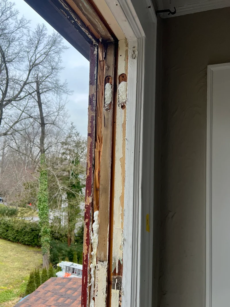 Foam insulating the double hung windows weight pockets
